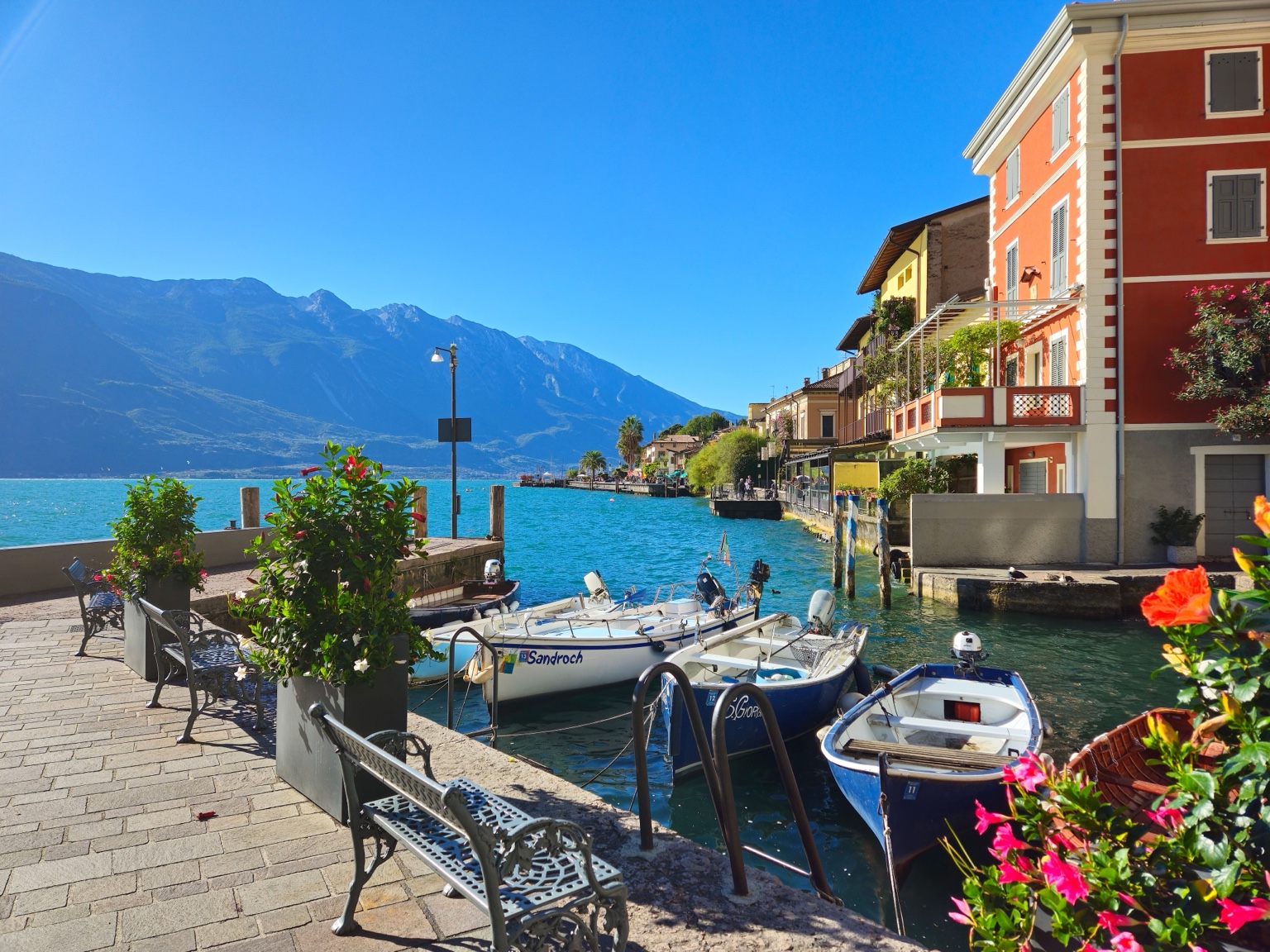 Boats along a colorful Lake Como waterfront