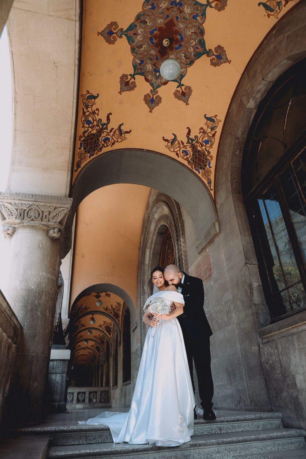 Wedding photo session beneath historic arches