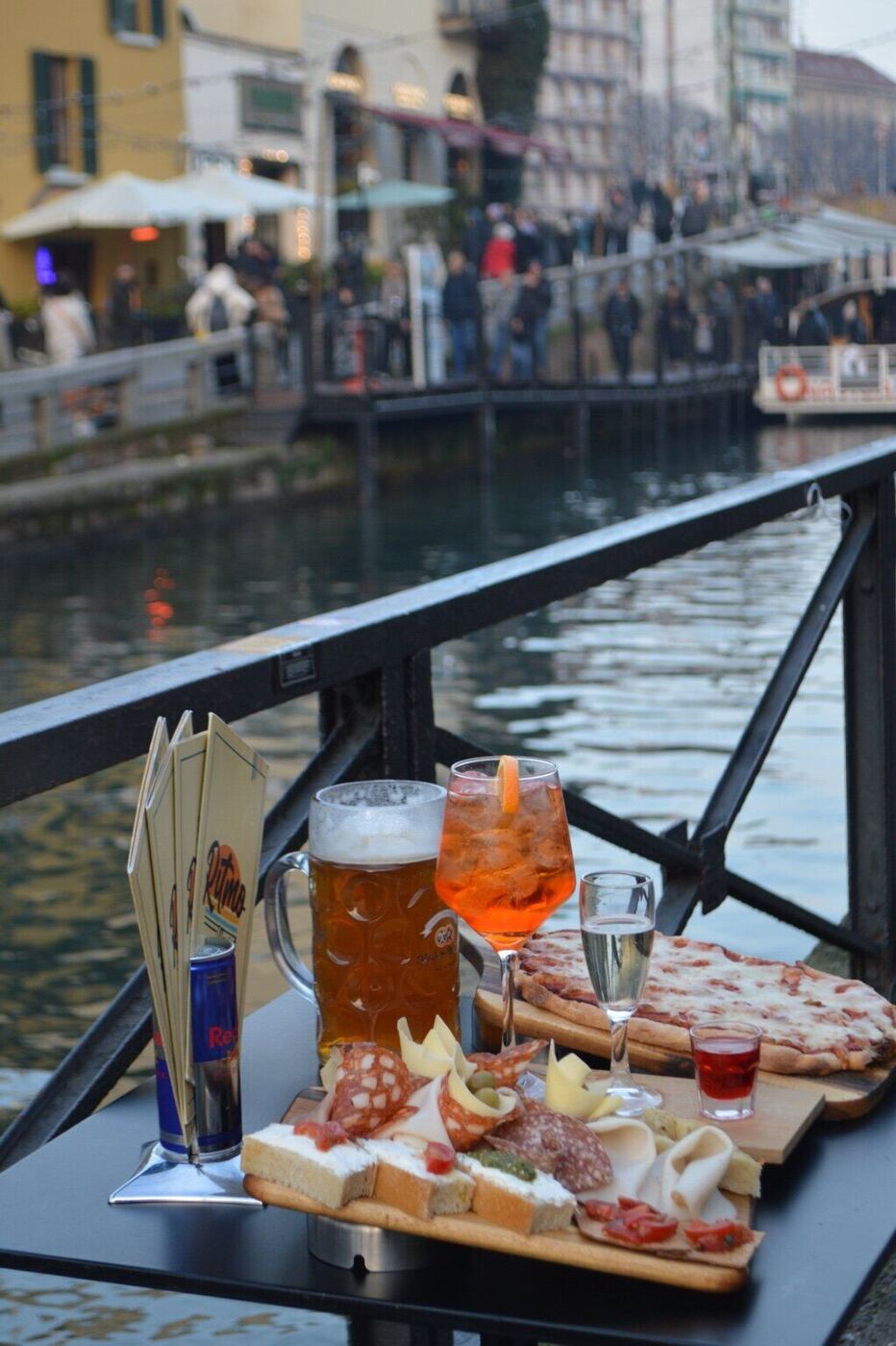 Aperitivo food and drinks beside Milan’s Navigli canals